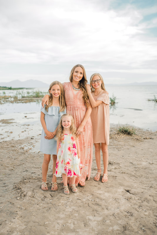 Family portrait of mother and daughters on the shores of Utah Lake by Flying Gull Photography