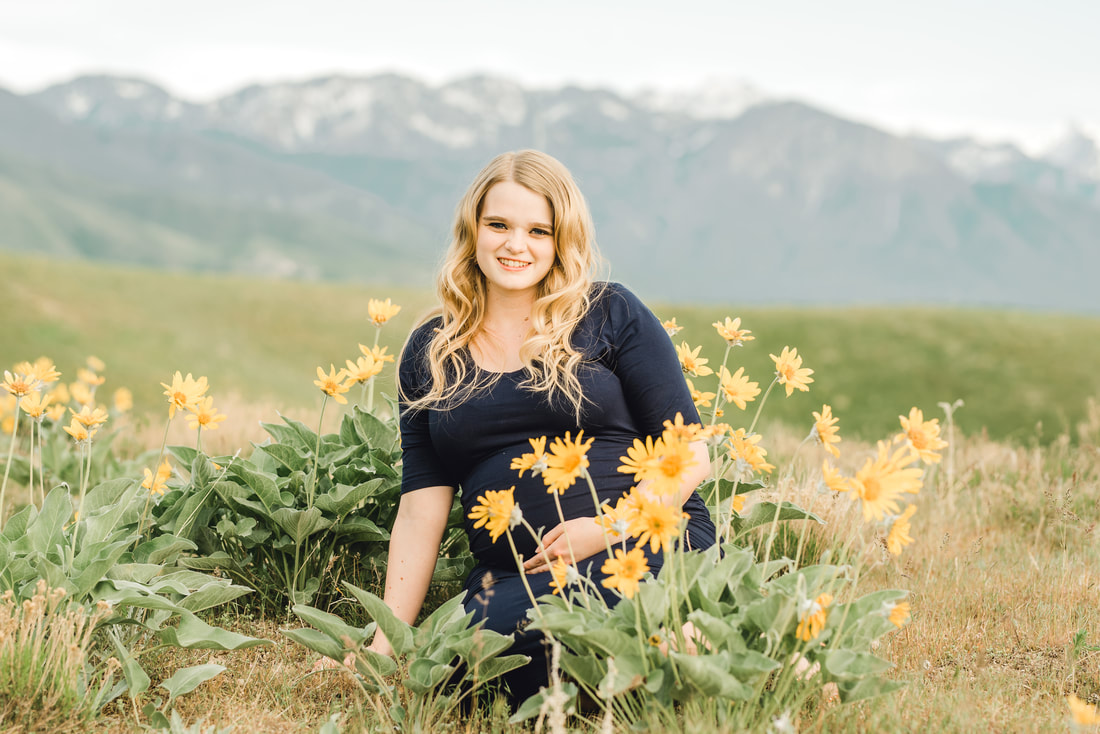 Maternity portrait in yellow flowers in Salt Lake City foothills