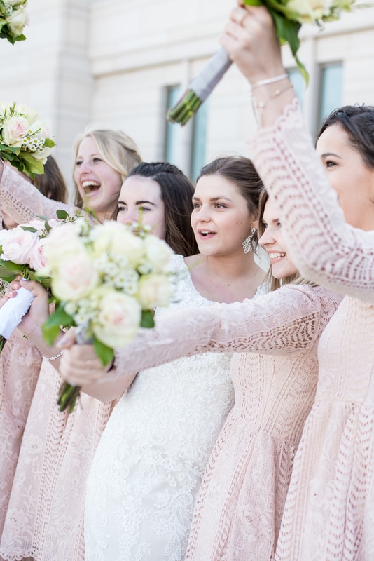Bride and Bridesmaids cheering with bouquets