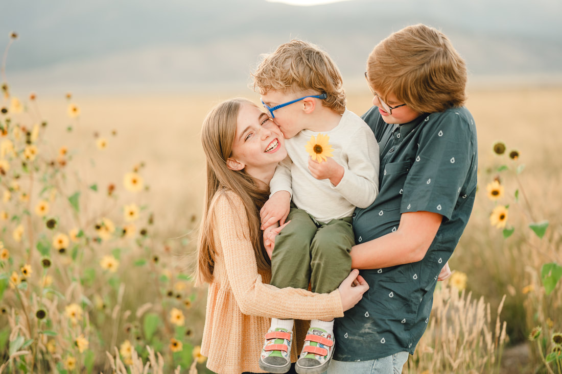 Siblings snuggle each other during fall family photos in Eagle Mountain by Flying Gull Photography
