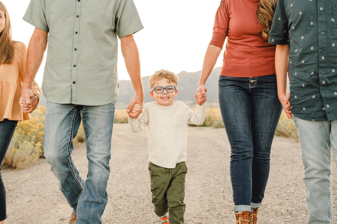 Family walks together during family photos in Eagle Mountain, Utah