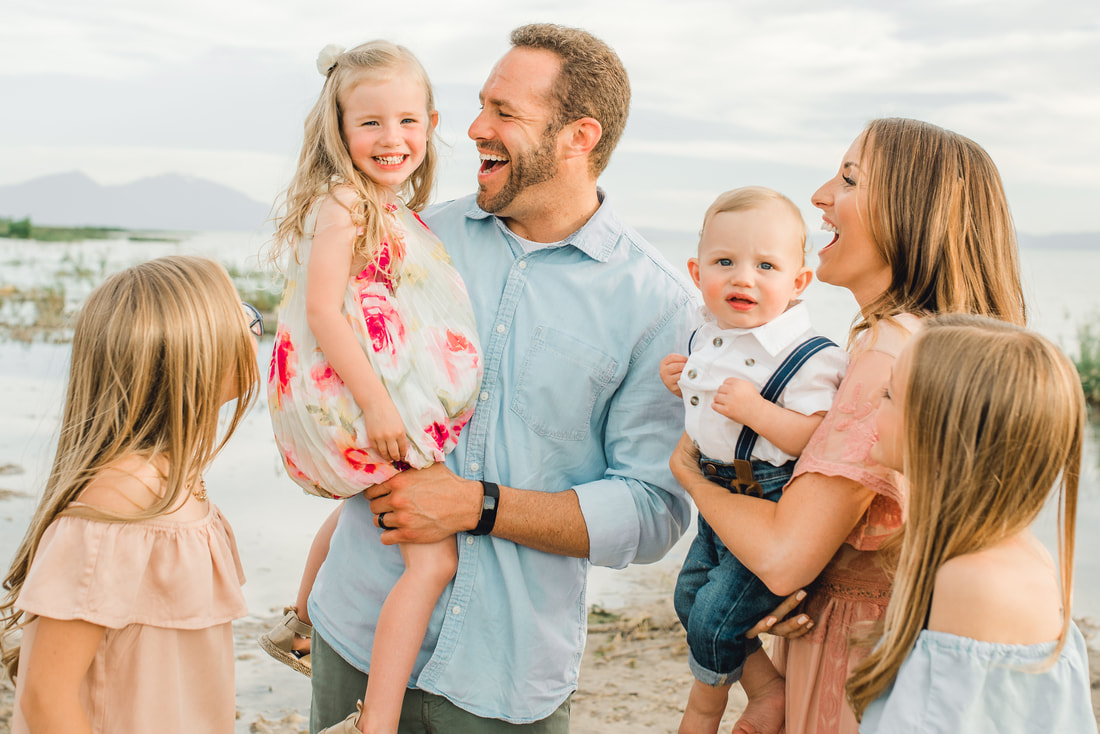 Family laughing together near Utah Lake
