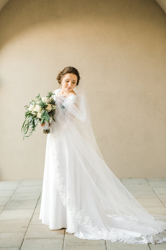 Bride with long veil in simple elegant setting