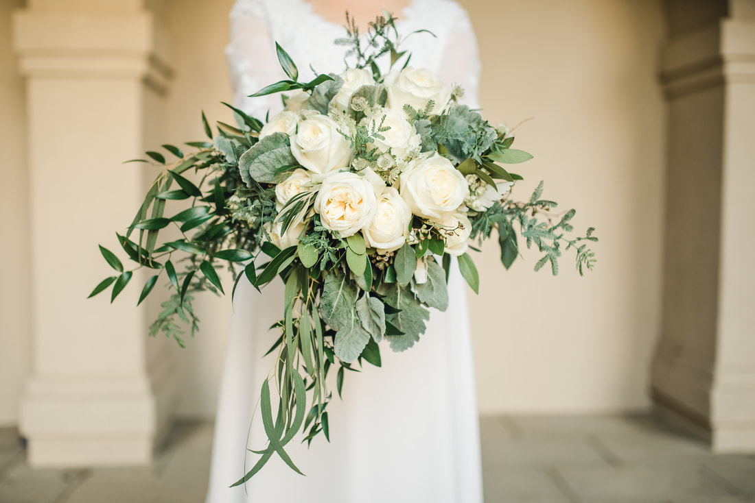 All white bridal bouquet with roses and eucalyptus