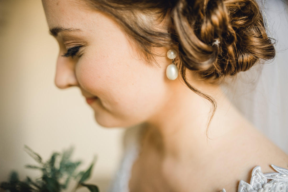 Bride close-up with pearl earrings