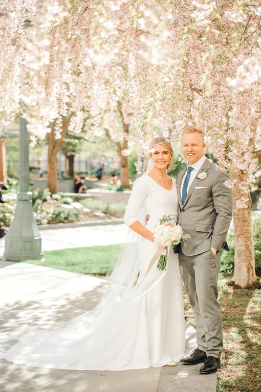 Husband and wife portrait in front of a weeping cherry tree