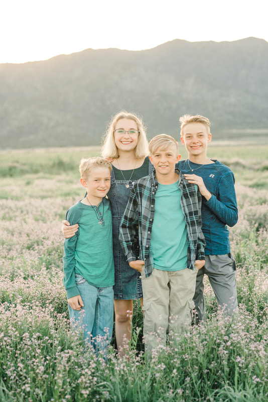 Family portrait in a field of wildflowers in Eagle Mountain Utah