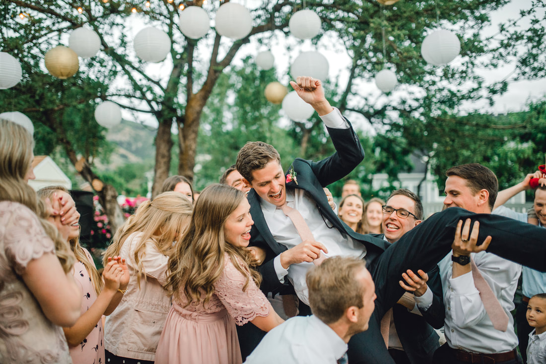 Crowd-surfing groom at a Utah wedding