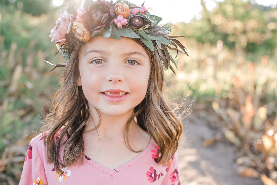 Close up portrait of a girl with a flower wreath on her head at Squaw Peak, Utah