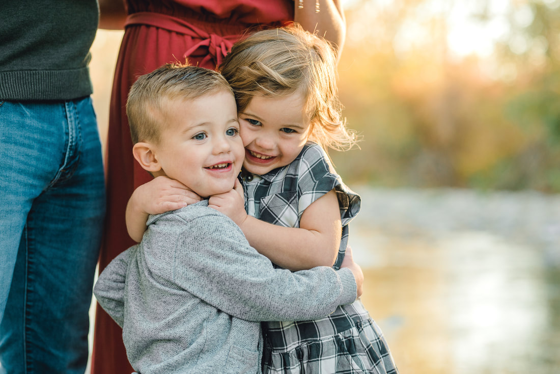 Siblings hug during family photo session in Highland, Utah