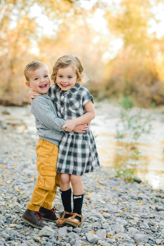 Fall photo of a brother and sister hugging