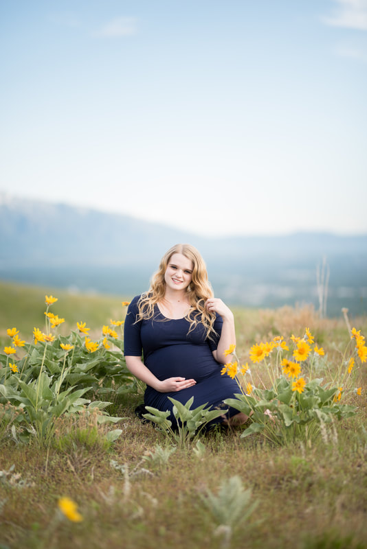 Mountain Maternity pictures with mom in blue dress surrounded by yellow flowers in Utah