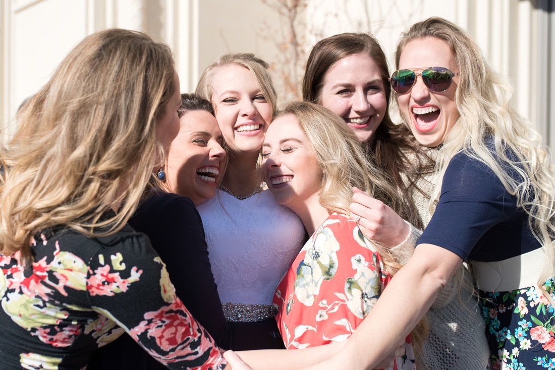 Friends and bridesmaids hugging bride after exiting Payson Temple