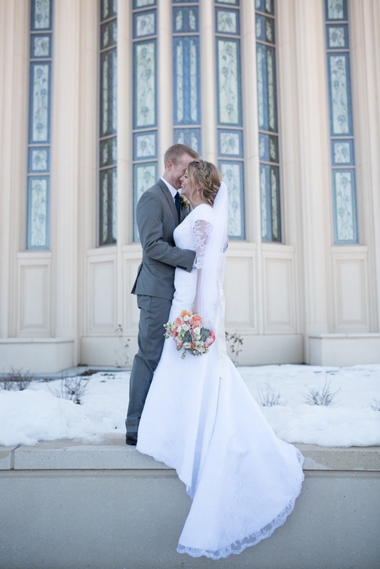 Photo of wedding couple laughing in front of Payson Utah Temple