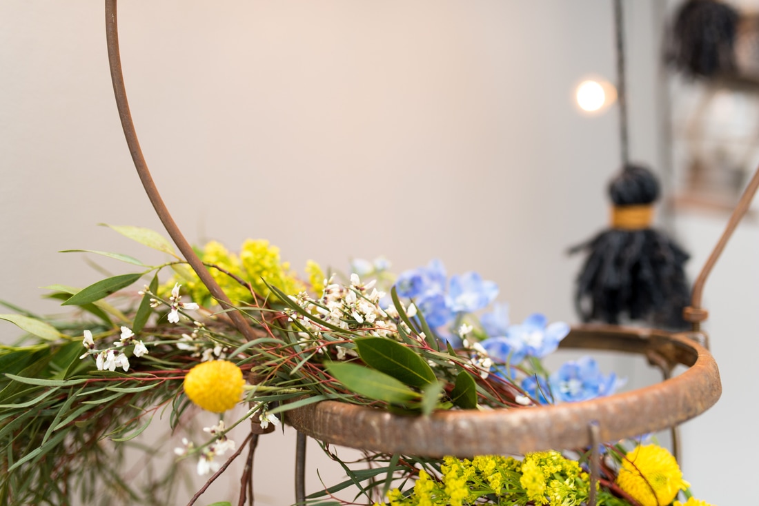 Wildflower-filled hanging basket at boho wedding photoshoot