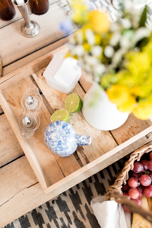 Boho picnic wedding details, salt shakers, white vase, limes, blue china