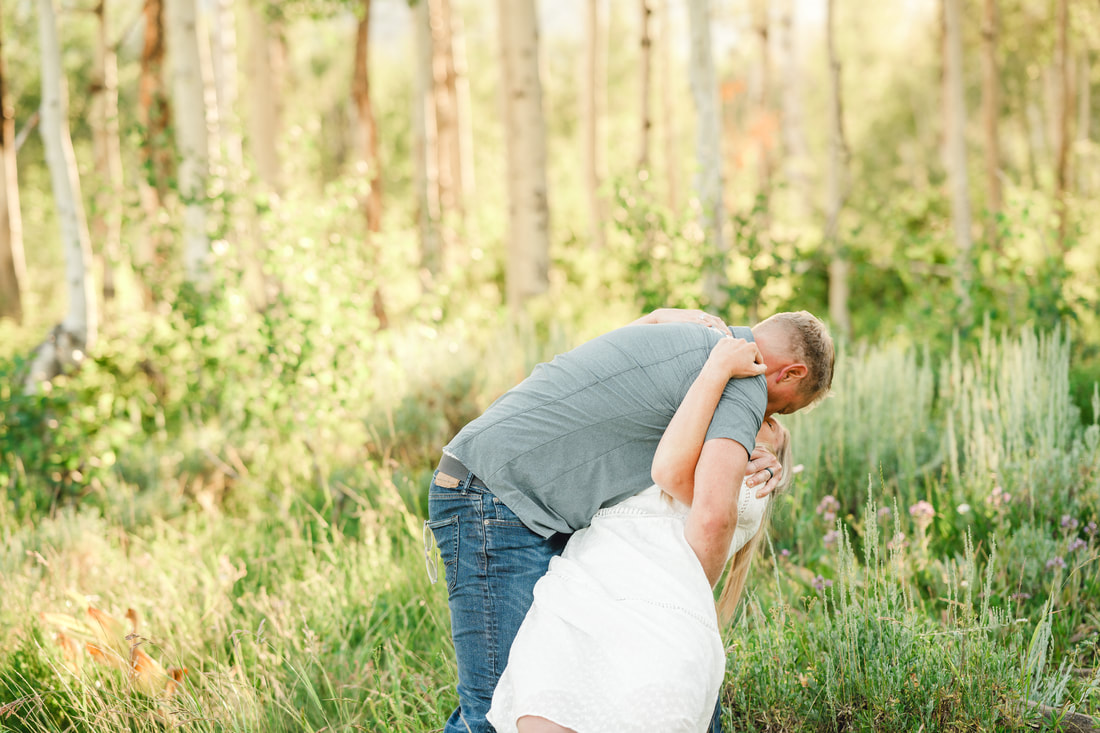 Husband dipping his wife during family photos