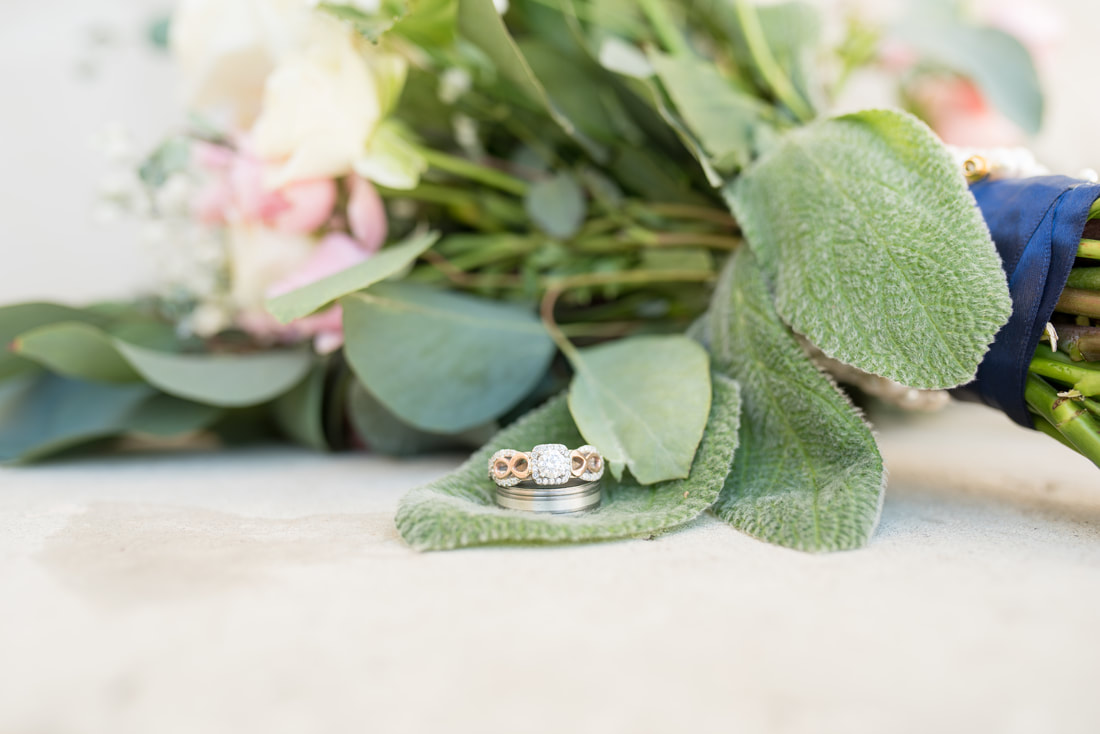 Wedding rings resting on bouquet with lamb's ear Manti, Utah wedding photographer Flying Gull Photography