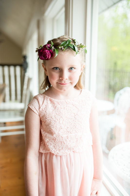 Flower girl in pink dress with floral crown